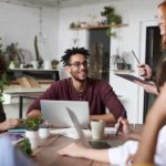 Happy people at work, working together with work colleagues.