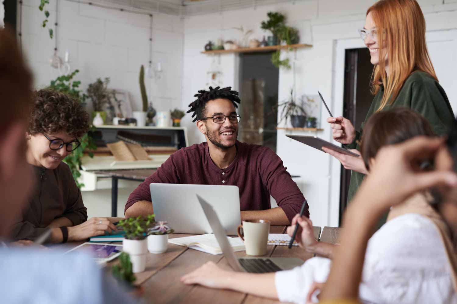 Happy people at work, working together with work colleagues.